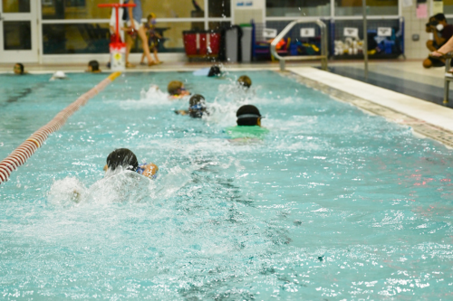 Students swimming in the indoor pool