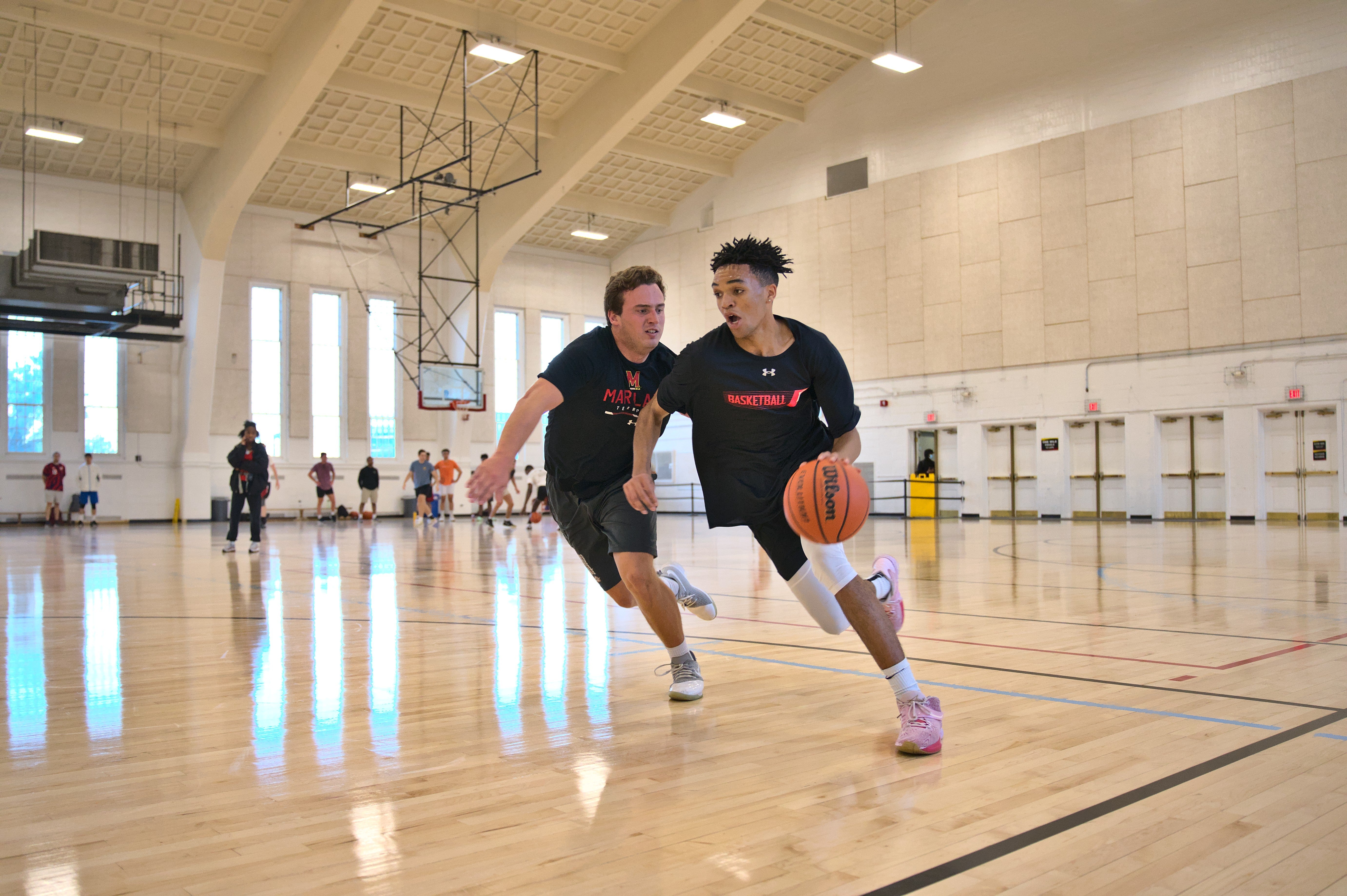 2 men playing basketball