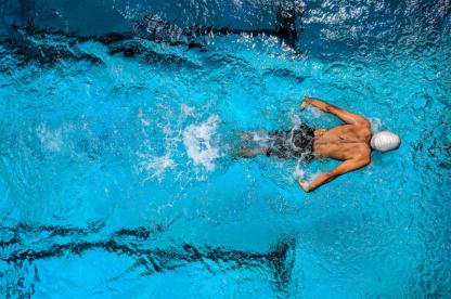 swimmer with a white swim cap 