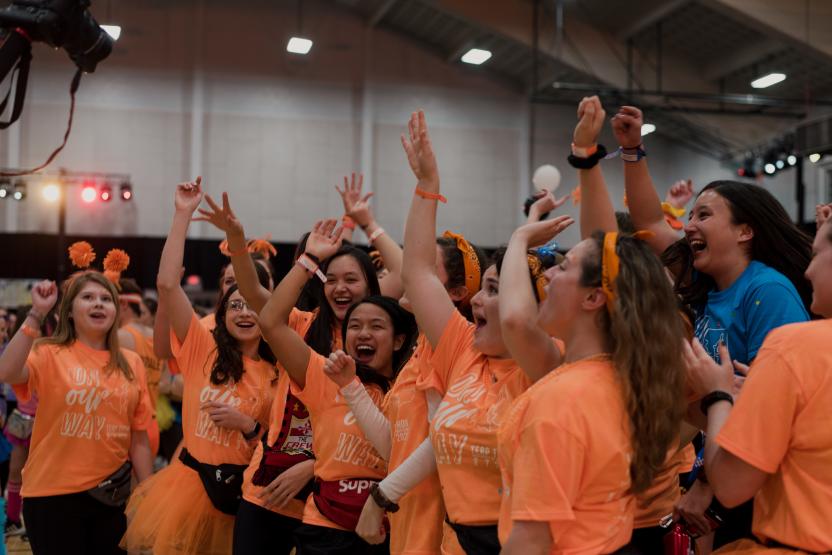 Terp Thon participants in orange shirts cheering 