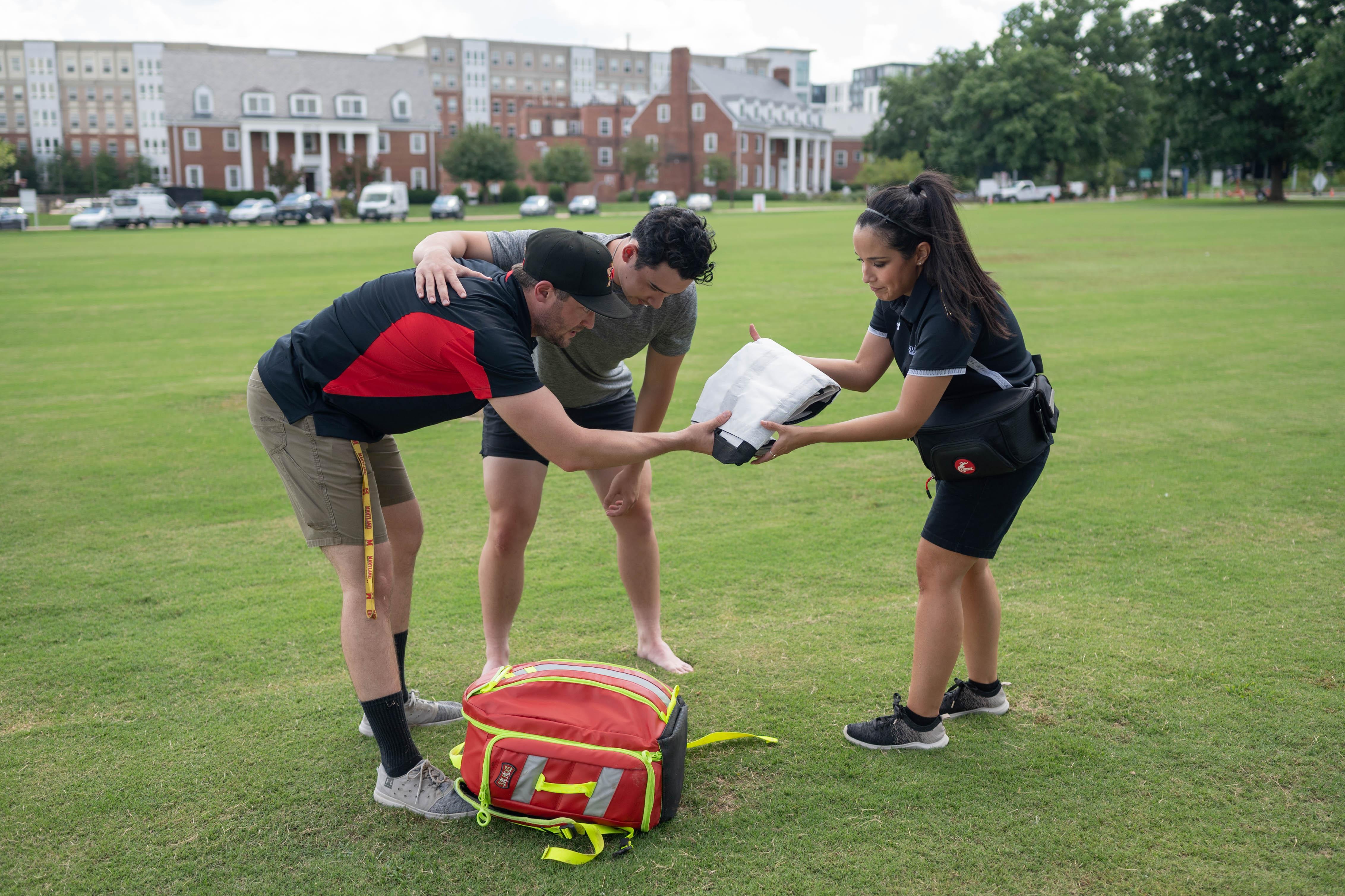 athletic trainers assisting athlete