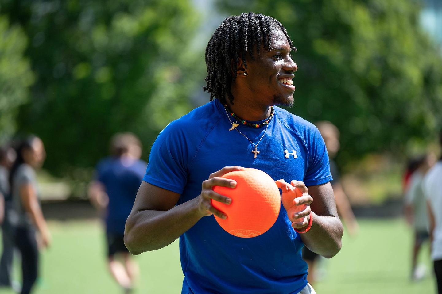 man playing dodge ball outside