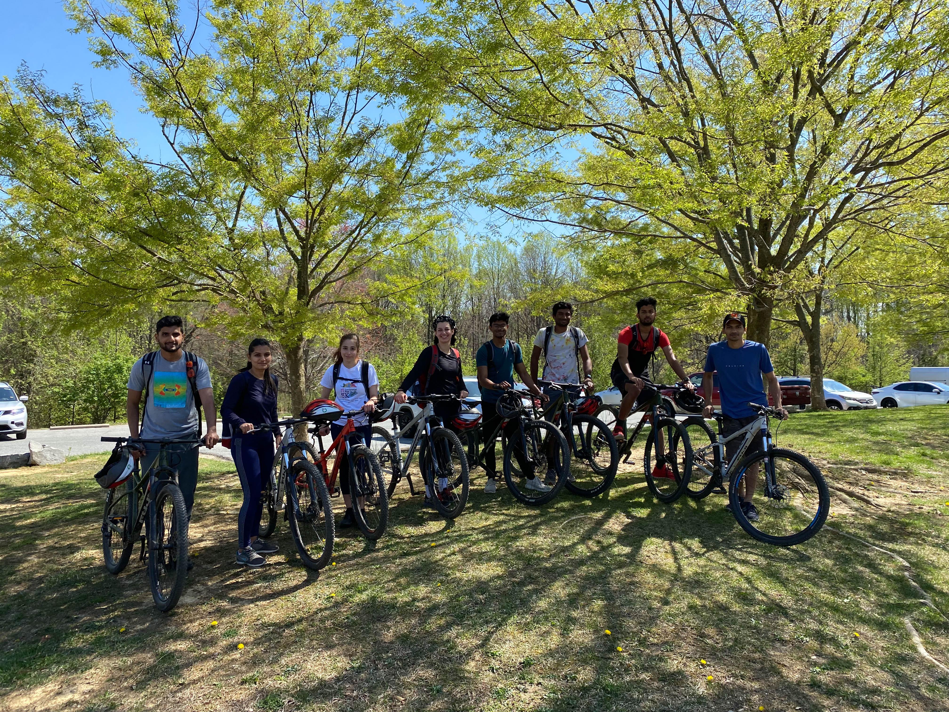 Mountain biking group of people outside with their bikes