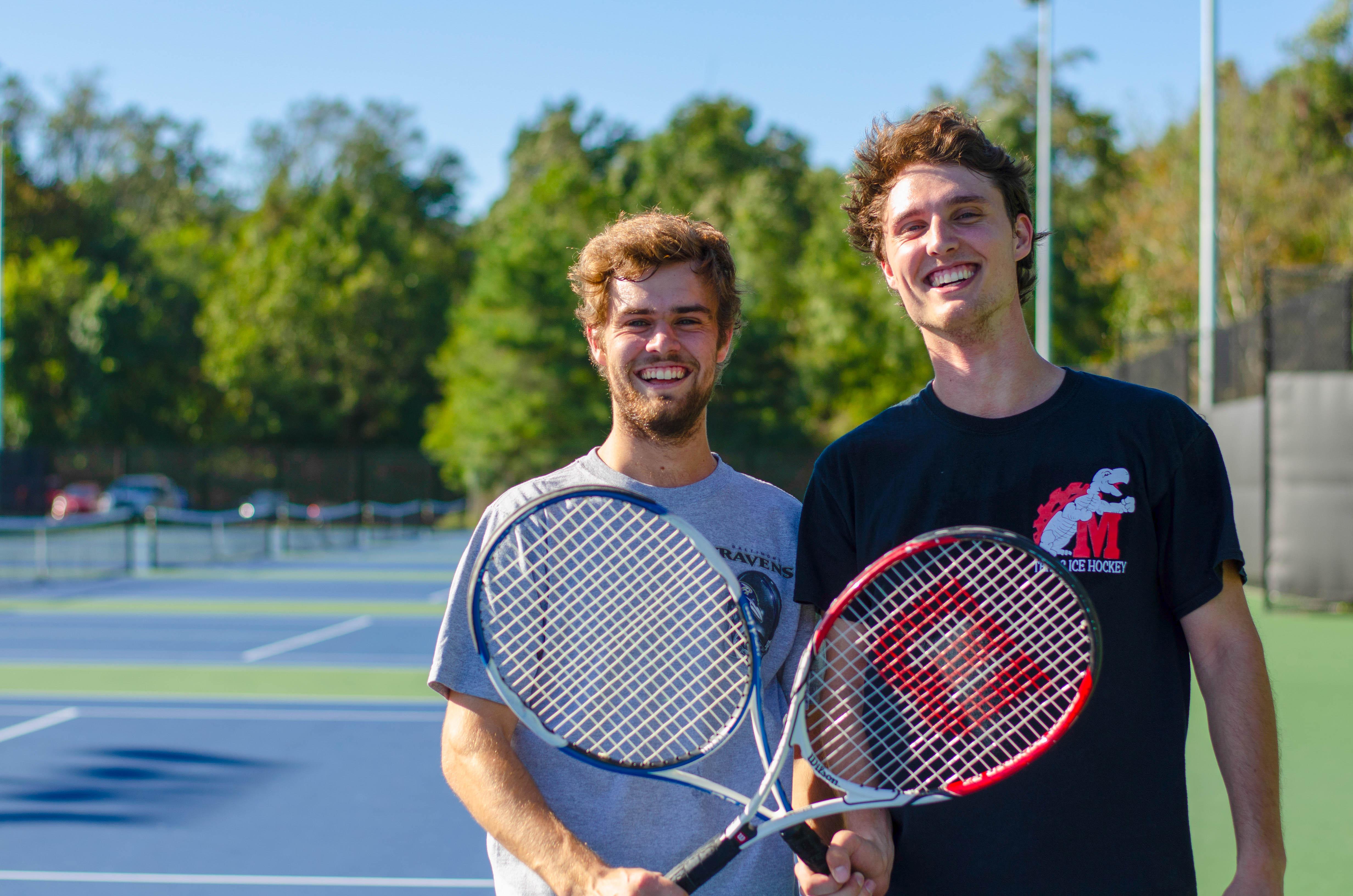 men posing racquets 